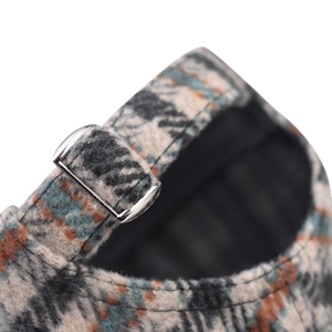 Detail of premium wool houndstooth baseball cap featuring a vintage metal adjustable buckle