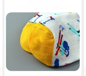 Detail of seamless reinforced toe on white mid-calf cotton socks with yellow accent