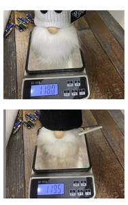Close-up of Halloween gnome plush weighing approximately 118 grams on a digital scale