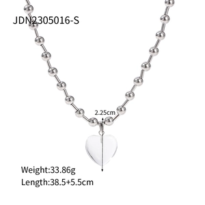 Detail view of titanium steel bead necklace with a 2.25cm transparent heart pendant