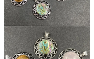 Close-up of star pendants with abalone shell, tiger eye and rose quartz stones