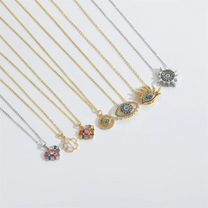 Detailed view of Devil's Eye pendant necklaces with colorful zircon and pearl inlays