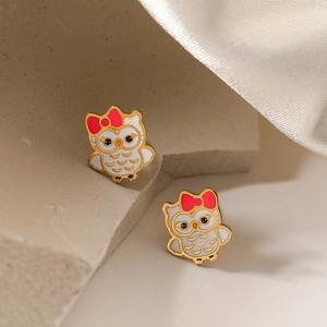 Cute 18K gold plated owl stud earrings with red bow on elegant silk background