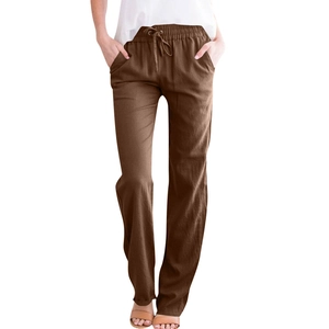 Detail of loose fit cotton linen pants featuring drawstring waist and side pockets