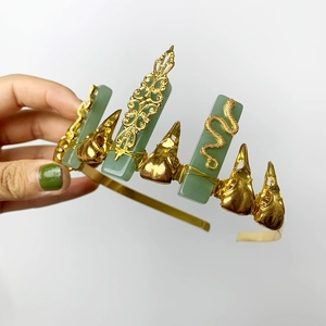 Golden crown with green aventurine stones, snake elements and raven skull decoration