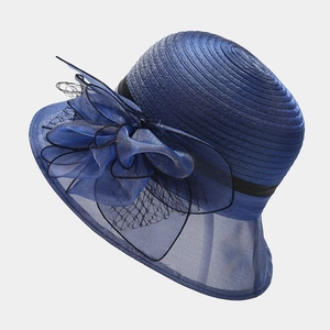 Close-up of elegant navy organza flowers and woven texture on a sun hat brim