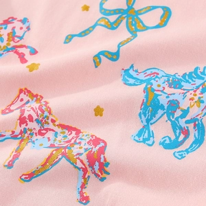 Pink cotton t-shirt fabric detail with cute colorful ponies and gold star prints