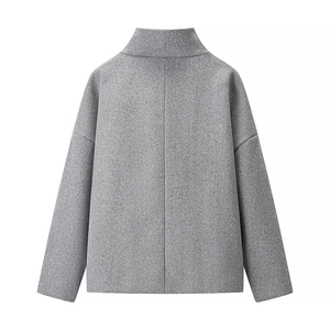 Detail of grey cropped wool coat showing the textured fabric back and high collar