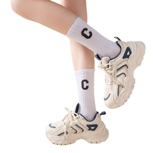Beige chunky platform sneakers with navy accents and breathable mesh on white background