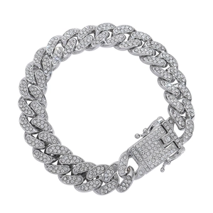 Detailed close-up of a silver-toned Cuban link bracelet with iced-out clear rhinestones