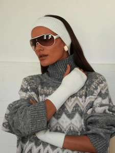 Detail of white ribbed knit headband and long fingerless gloves on a model