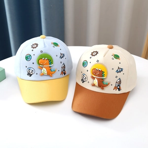 Detail view of kids dinosaur baseball caps with color-blocking and cartoon astronaut patches