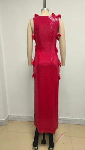 Detail view of red sequin evening dress featuring 3D bow accents and sparkling texture