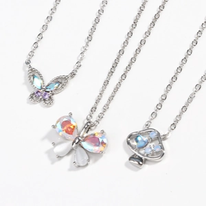 Elegant gold-plated necklaces with butterfly and opal pendants on a white background