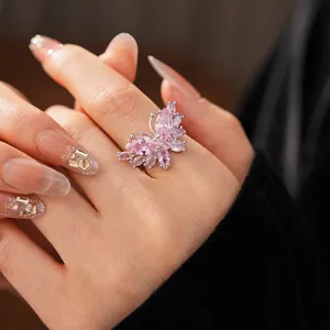 Minimalist silver butterfly open ring with pink zircon stones worn on finger