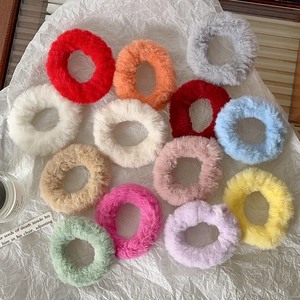 Detailed set of 12 colorful faux rabbit fur elastic hair ties on textured paper