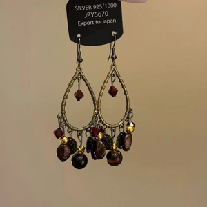 Detail view of Bohemian tassel earrings with leopard-pattern beads and 925 silver needles