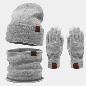 Detailed knit texture of grey winter set with snowflake leather patch and touch gloves