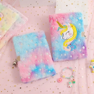 Detailed view of plush unicorn notebook featuring gradient colors and a metal heart lock