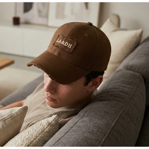 Detail of distressed brim and LA&DH letter embroidery on vintage brown baseball cap