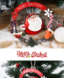 Detailed view of Merry Christmas rattan wreath with Santa and wooden sign on wood