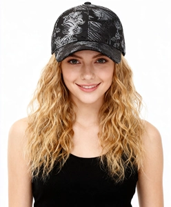 Detailed view of black baseball cap featuring silver dragon totem and artistic textures