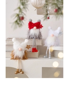 Three Christmas gnomes with long legs sitting on books for cozy holiday home decor