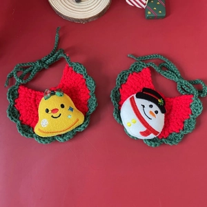 Detail of handmade crochet pet bib with snowman and bell for festive Christmas decor