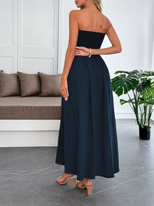 Rear view of long navy blue strapless vacation dress with soft flowing fabric texture