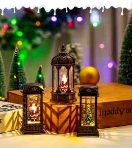 Close-up of LED Christmas lantern with Santa Claus and a miniature tree inside