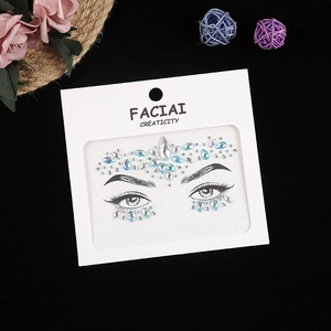Macro detail of blue and green gradient facial rhinestone stickers on white packaging