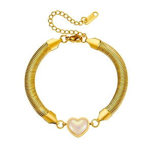 Macro detail of gold stainless steel snake chain bracelet with pearl heart pendant
