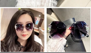 Detail of rimless sunglasses with purple gradient lenses and floral rhinestone embellishments