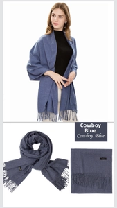 Detail of cowboy blue cashmere scarf featuring soft texture and classic fringe edges