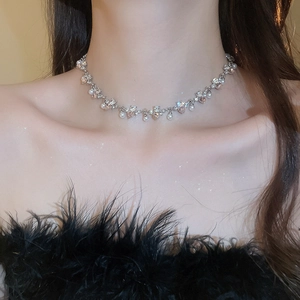 Detail of a pearl and pink rhinestone heart necklace worn on the neck with a star filter