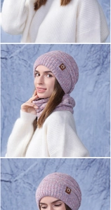 Close-up of winter knit hat and scarf set featuring mixed pink yarn and leather patch