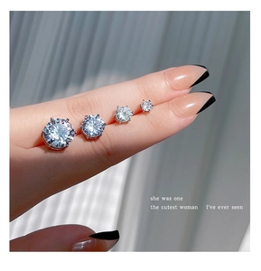 Macro shot of silver stud earrings in four sizes with sparkling cubic zirconia stones