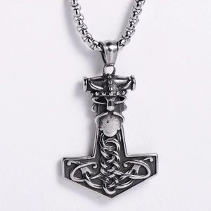 Macro shot of Viking Mjölnir pendant in vintage stainless steel with Nordic warrior relief