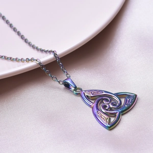 Detail of a rainbow-plated Celtic Triquetra knot pendant on a delicate stainless steel chain