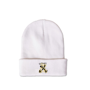 Detail of white cuffed beanie with black lettering and yellow bear graffiti pattern