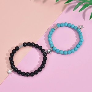 Close-up of pink zebra stone and black bead bracelets with heart-shaped magnetic clasp