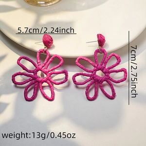 Detail view of handmade woven raffia flower earrings in vibrant rose red with dimensions