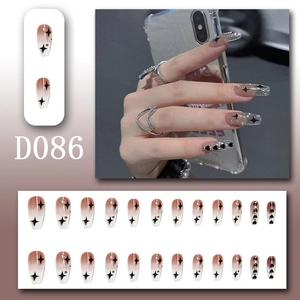 Detail of 24pcs long coffin press-on nails with black stars, hearts and silver rhinestones
