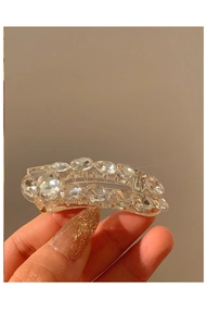 Macro shot of a clear rhinestone hair clip with premium sparkling artificial crystals
