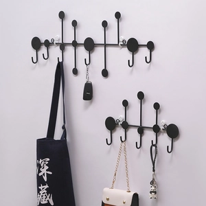 Modern black geometric wall mounted coat rack with multiple hooks for home storage