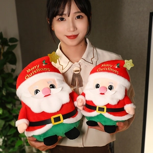 Plush Santa Claus dolls with Merry Christmas embroidery held by a person in a festive setting