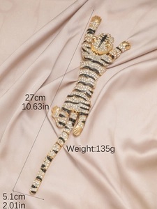 Detailed view of luxury tiger brooch with gold alloy, black enamel and white crystals