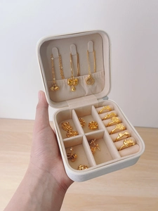 Detailed interior of portable jewelry box with necklace hooks and velvet ring slots