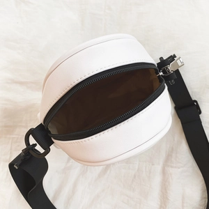 Detail view of the white round PU leather crossbody bag showing internal storage space