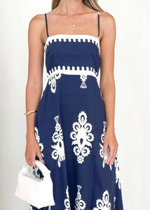 Detail of navy blue ethnic sundress with white embroidery and fabric texture details